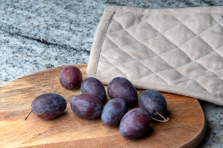 Hungarian plums on a cutting boardの写真素材