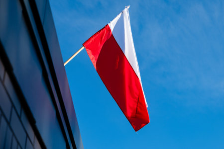 Polish flag against a blue sky backgroundの写真素材