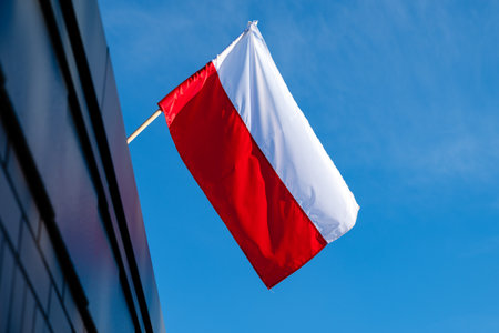 Polish flag against a blue sky backgroundの写真素材