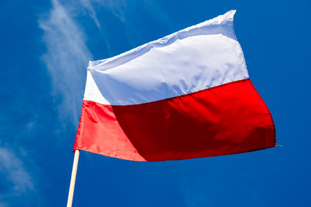 Polish flag against a blue sky backgroundの写真素材