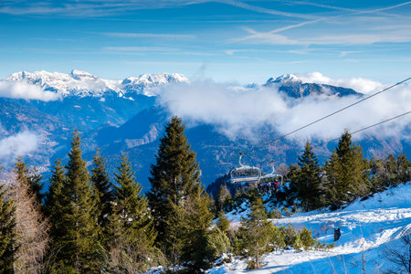 Ski resort in Alps mountains. Ski lifts and snowboardersの写真素材