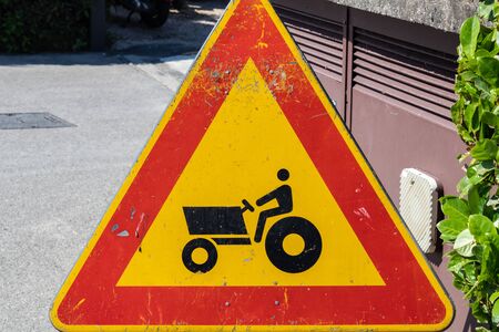 Tractor caution sign, farm vehicle crossing warning sign closeup - Imageの写真素材