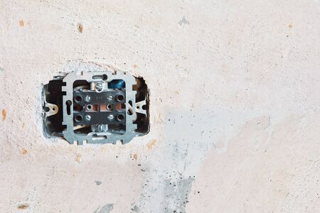 broken socket in concrete wall