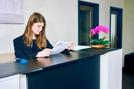 woman office manager at the desk at the receptionの写真素材