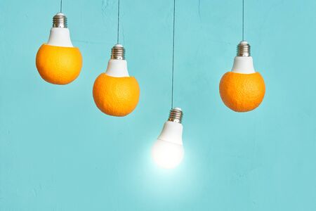 led light bulb. oranges in a lamp on a turquoise backgroundの写真素材