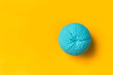 painted orange in cyan color on a yellow background. creative design conceptの写真素材