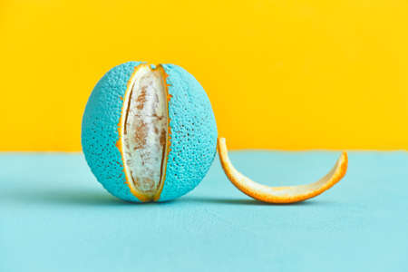 peeled lobule peel of an orange painted in turquoise color. creative design concept