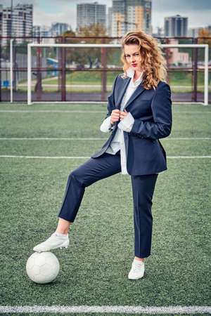 portrait of beautiful young woman soccer player at stadium with ballの写真素材
