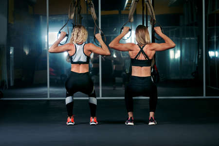 two women work out in the fitness gym