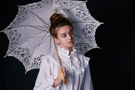 vintage portrait of teenage girl in retro dress with white umbrella