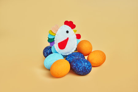 toy chicken on easter eggs. yellow backgroundの写真素材