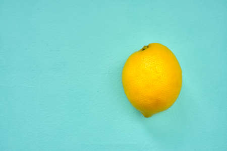 fresh yellow lemon on turquoise background. copy spaceの写真素材