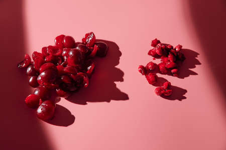 peeled ripe pitted cherries. pink background