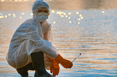 checking the water by a specialist in a protective suit and mask