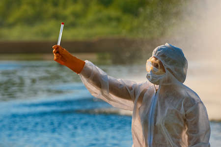 checking the water by a specialist in a protective suit and mask