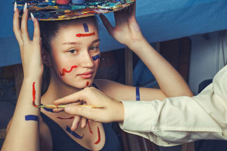 male artist paints on the girl's body. body painting creativeの写真素材