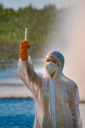 checking the water by a specialist in a protective suit and mask