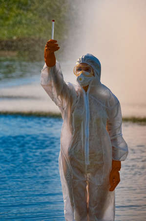 checking the water by a specialist in a protective suit and maskの写真素材