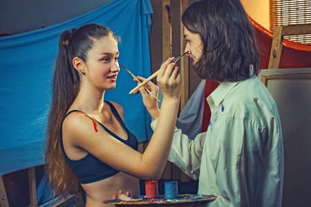 young couple artists paint bodypainting