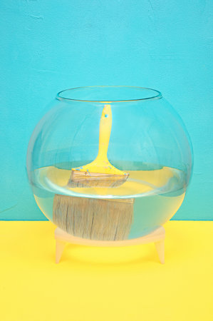 yellow construction brush in an aquarium with water. blue backgroundの写真素材