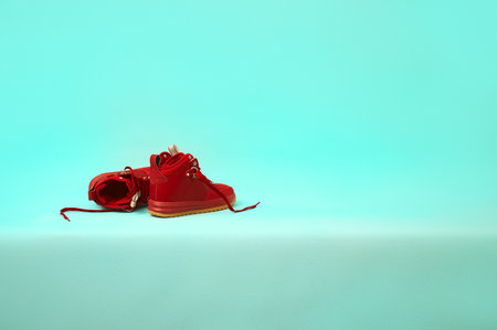 new burgundy sneakers on the table. concept design. copy spaceの写真素材