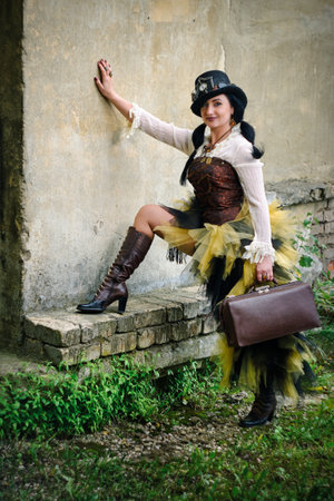 retro portrait of a beautiful woman with a suitcase. steampunk styleの写真素材