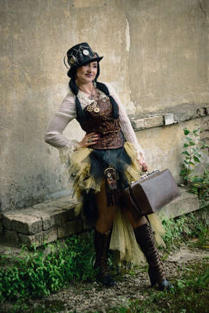 retro portrait of a beautiful woman with a suitcase. steampunk style