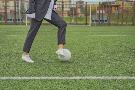 woman soccer player with ball on the field. ball dribbling, feintの写真素材