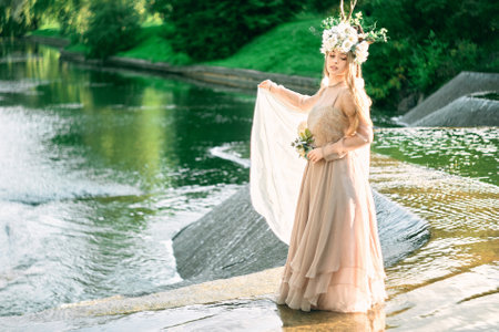 Portrait of glamorous cute teenage girl in nature near the riverの写真素材