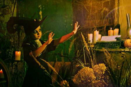 fairy tale portrait of a little girl in a big hat on her head. halloween conceptの写真素材