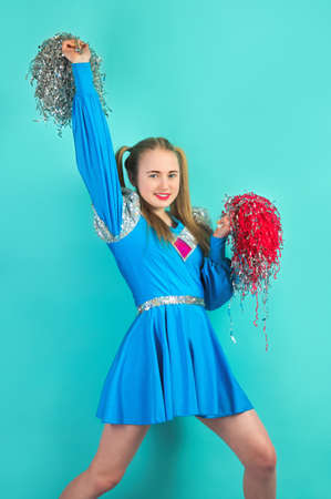 portrait of young cheerleader girl from cheerleading group. turquoise background