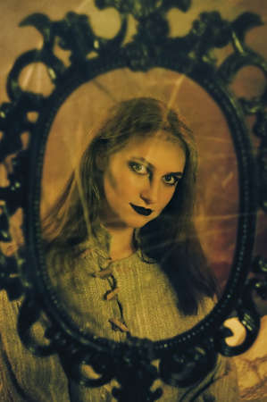 retro art portrait of a young girl in the mirrorの写真素材