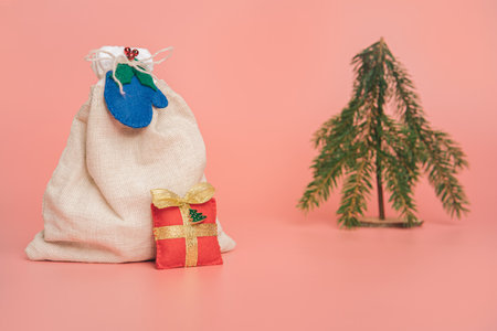 Christmas gift sack. minimal style. pastel pink background