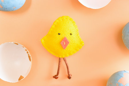 Diy easter chicken in eggshell. concept. beige background. layout.