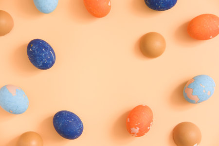 Copy space Easter colored eggs on a beige background. frame. mockup.