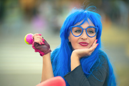 Portrait of a glamorous woman with blue hair and glassesの写真素材