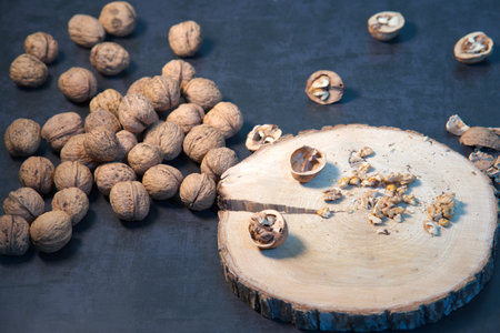 Peeled walnuts on a wooden board on the kitchen table