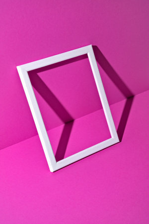 White photo frame on a magenta background. Minimalist concept designの写真素材