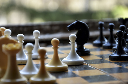 Multicolored figures at the chess boardの写真素材