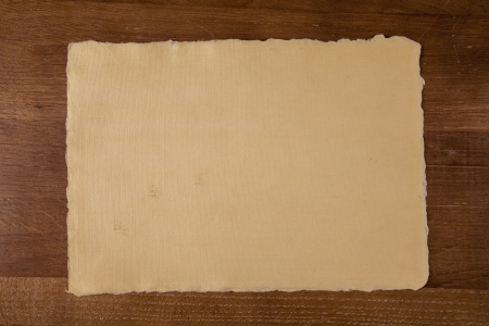 Sheet of handmade paper on wooden tableの写真素材