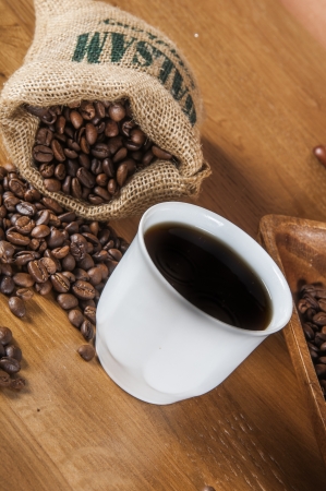 Coffee beans, wooden table with ambient lightの写真素材