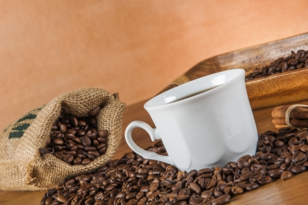 Coffee beans, wooden table with ambient lightの写真素材