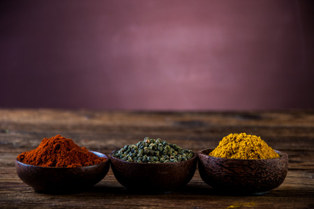 Hot spices in wooden bowlsの写真素材