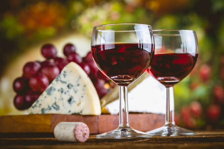 Glass of red wine on wooden tableの写真素材