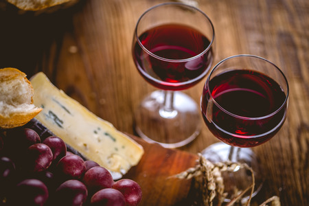Glass of red wine on wooden tableの写真素材