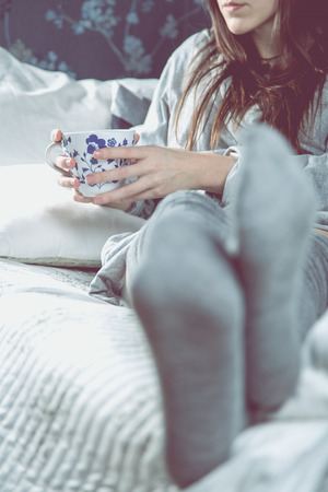 Relaxing day with tea an resting on the sofaの写真素材