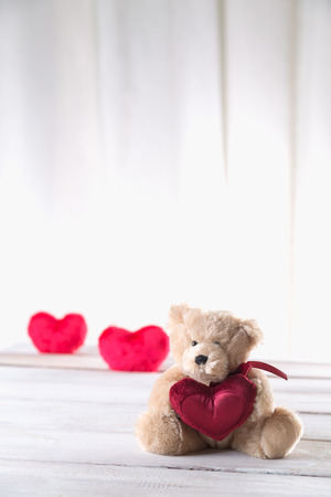 Cute valentines bear on a bright wooden backgroundの写真素材