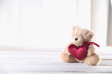 Cute valentines bear on a bright wooden backgroundの写真素材
