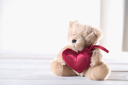 Cute valentines bear on a bright wooden backgroundの写真素材