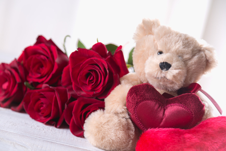 Cute Valentines teddy bear with red roses, love conceptの写真素材